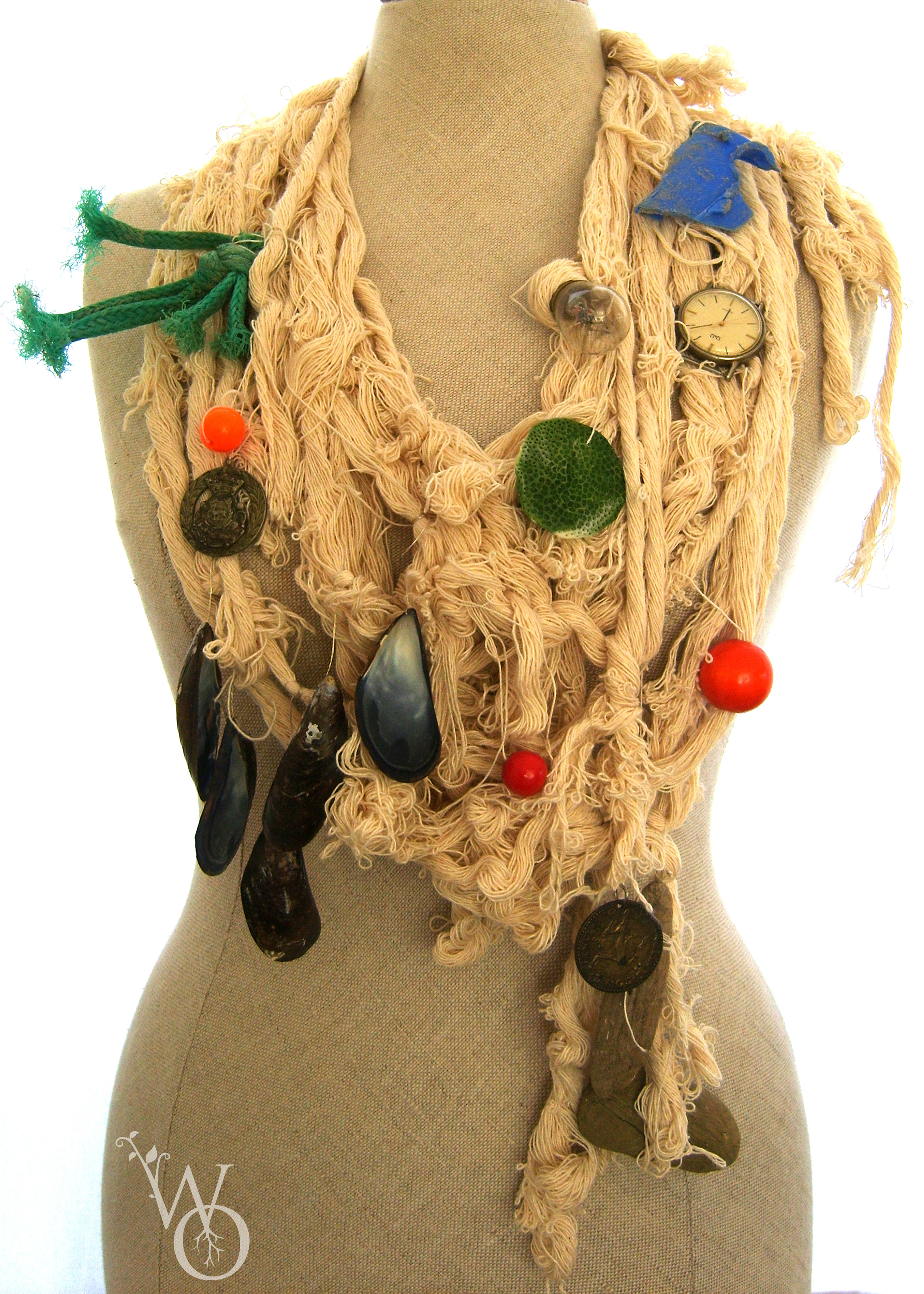 Necklace made from rope and various items natural and man made from the sea, watch parts.